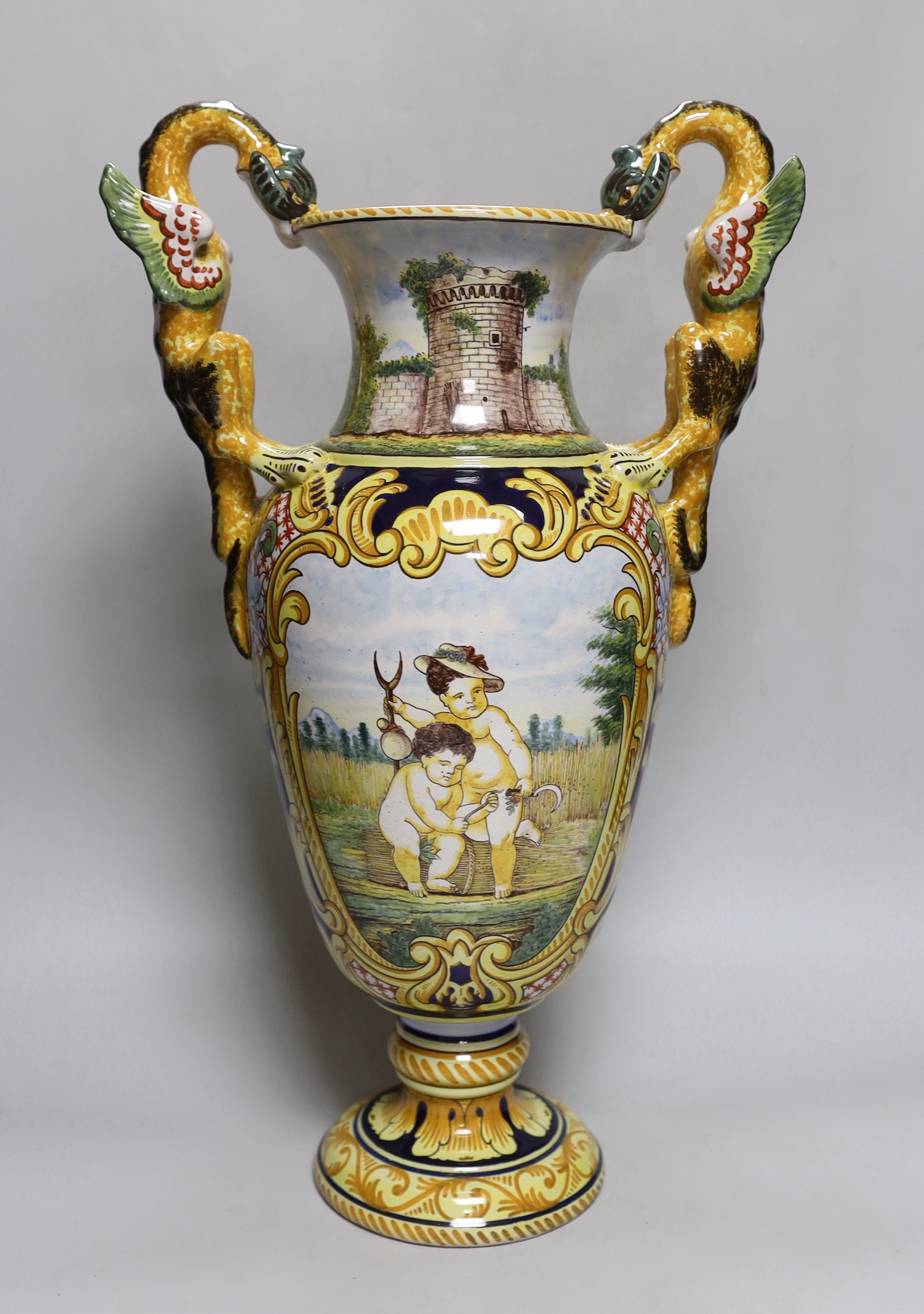 A Nevers faience two handled vase, signed A. Montagnon, 52cm high